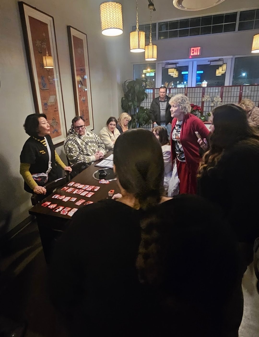 Guests learning Korean card games at Yummy's K-Drama Night